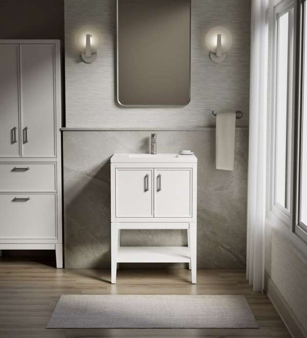 Vanité de salle de bain 24 po WINNOW de couleur blanche dans une salle de bain éclairée par des appliques murales et surmontée d'un miroir rectangulaire